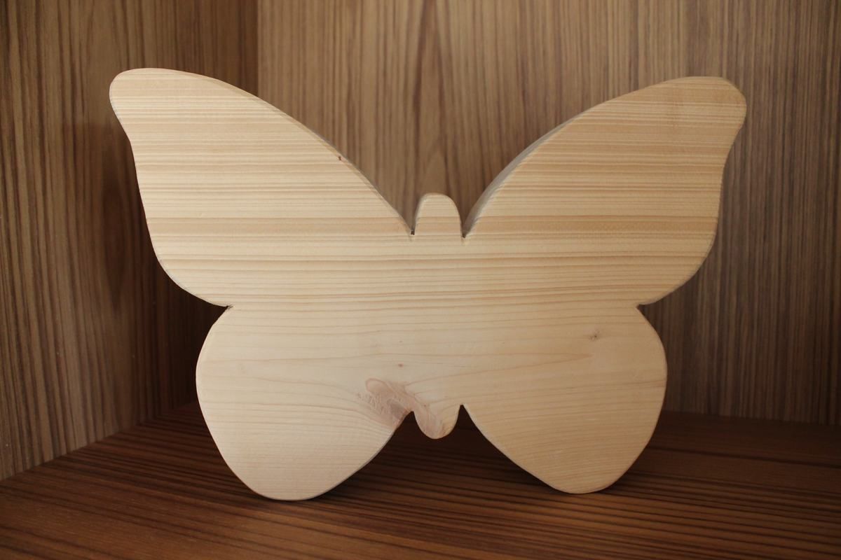 Schmetterling aus hellem Holz auf einem Holzregal